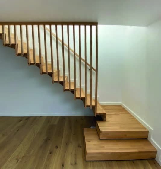 Escalier contemporain en bois avec des lamelles verticales, apportant une touche de design épuré à l'intérieur.